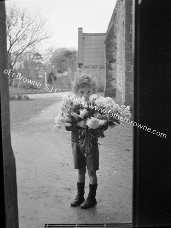 LITTLE BOY WITH FLOWERS FOR CHURCH